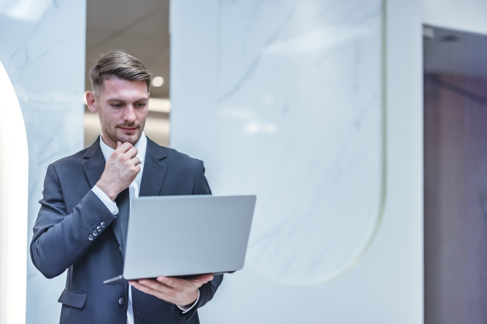 Confident man leads, showcasing leadership, strategic thinking, overseeing operations with laptop