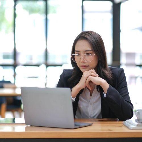 Professional Asian businesswoman or female manager is pensively thinking about a business plan or